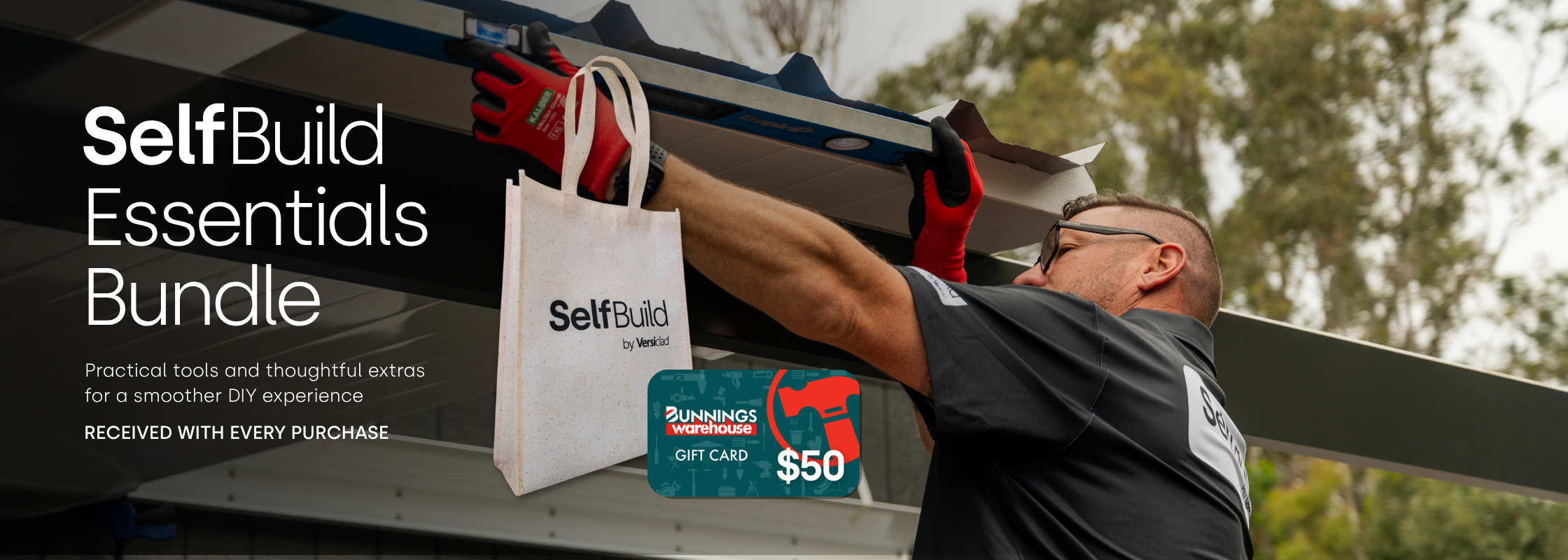 Person holding a 'SelfBuild' branded bag with tools and a gift card on a truck bed.