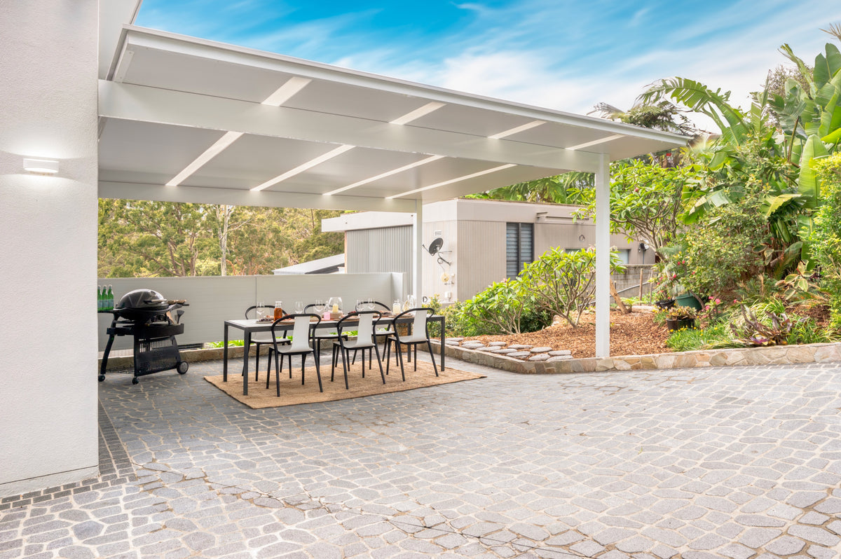 SelfBuild attached patio over a paved outdoor dining area