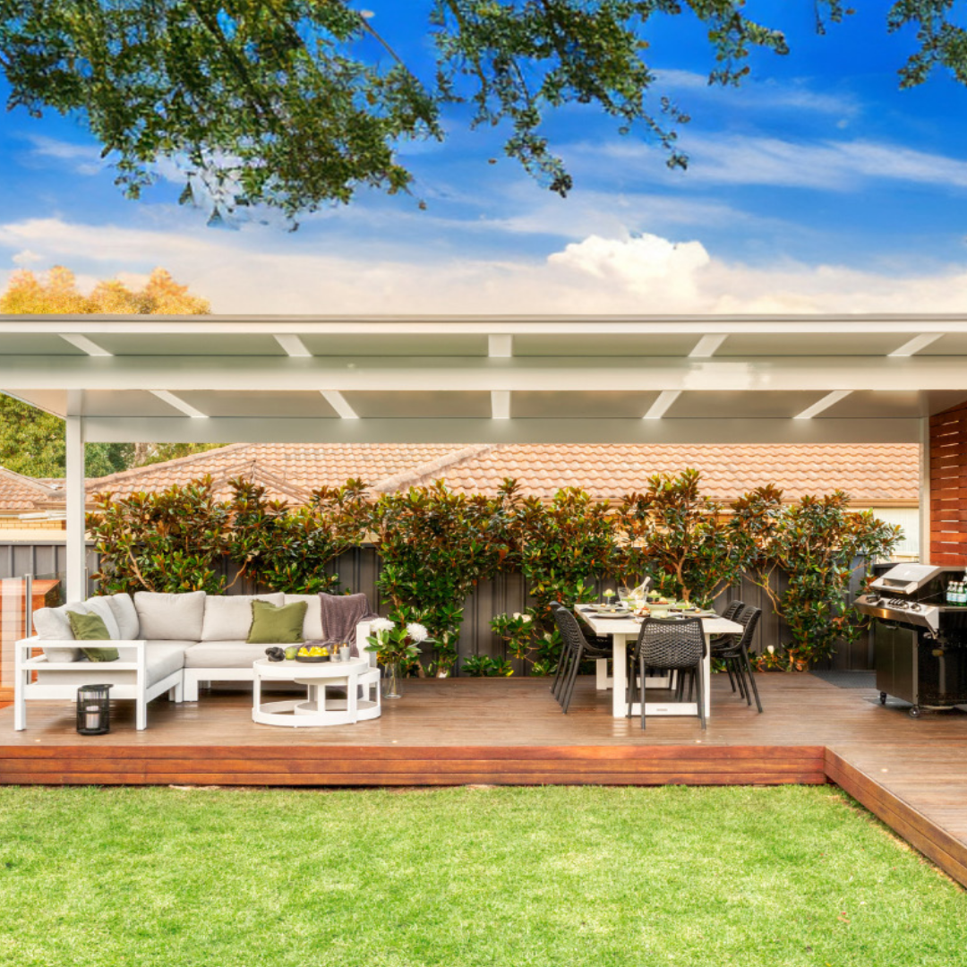 Outdoor patio area with furniture and grill on a sunny day