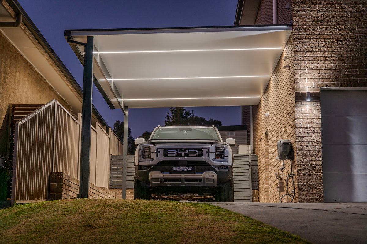 Attached patio carport with LED strip lighting at dusk